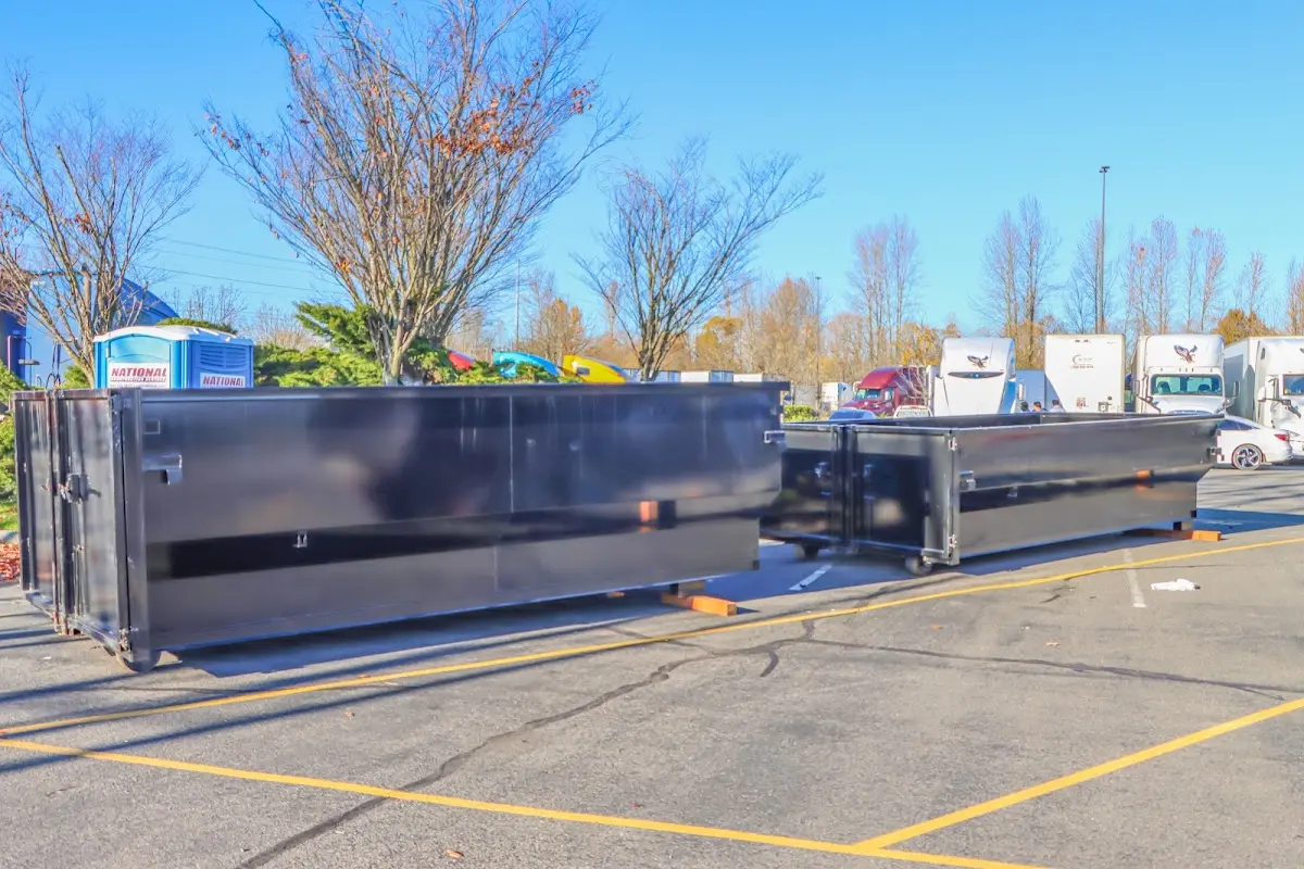 Professional dumpster rental service with roll-off container on residential driveway in Krum